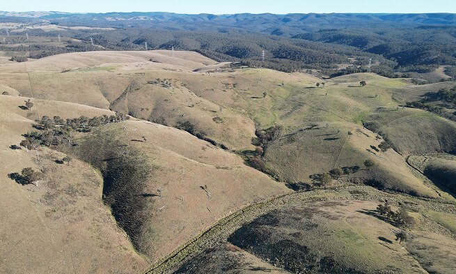 An aerial view of brown-green hills.